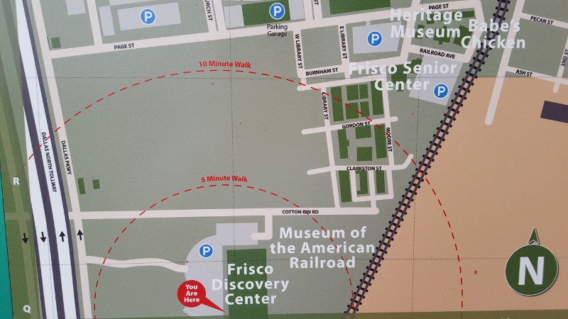 Signage showing walking distances and local attractions outside the Frisco TX Discovery Center (photo by Sheila Scarborough)