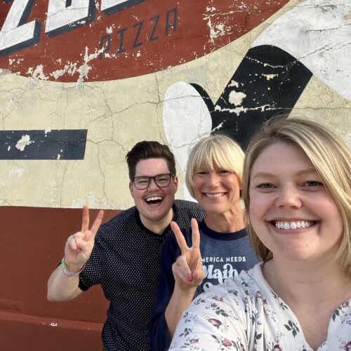 Three Main Street America Staff members standing in front of a mural in Marion, Iowa.