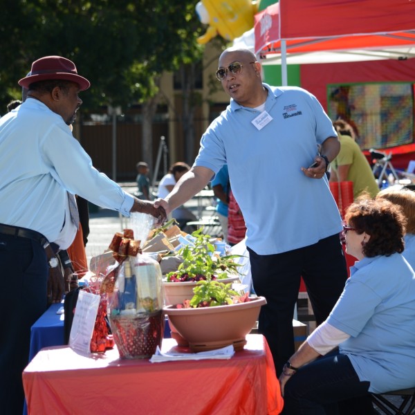 Men shaking hands at a community event.