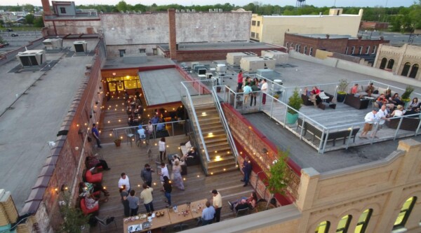 Overhead view of people socializing at the Dispensary, Downtown Florence's first rooftop entertainment facility.