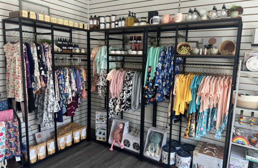 Small retail space with racks of clothing and accessories