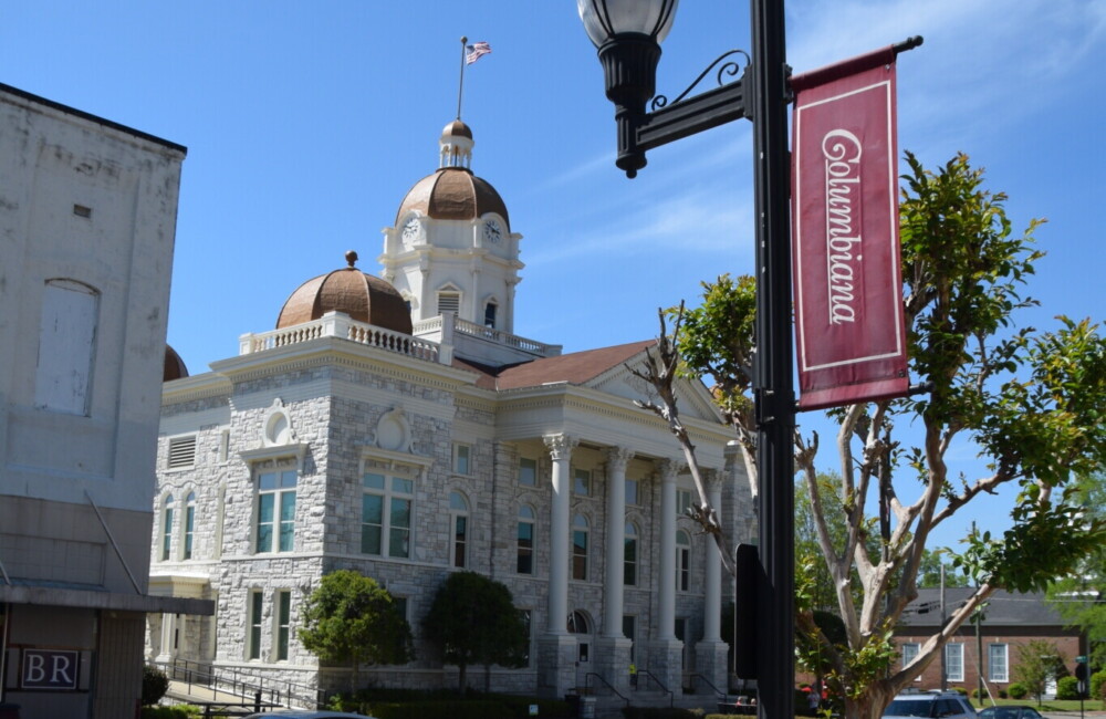 City hall building and street lamp with "Columbia" banner.