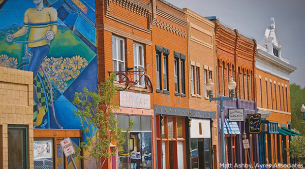 Historic buildings with small businesses and mural