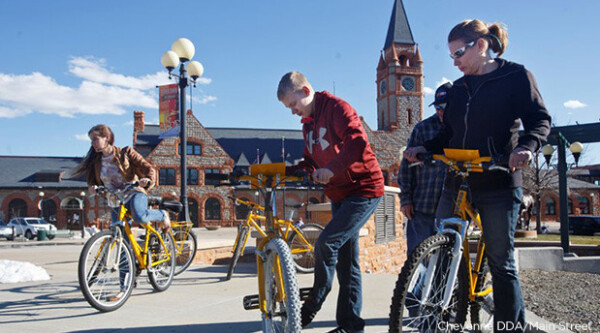 A group of people get on ride share bikes in Cheyenne, Wyoming.