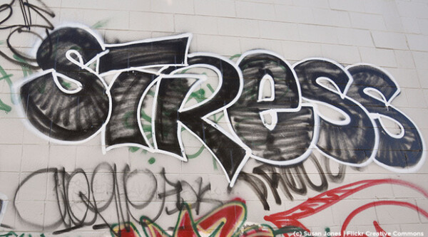 Graffiti art reading "Stress" on a stone wall