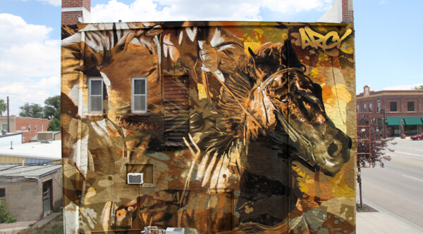 New “Deliverance” mural, depicting a horse, in Glenrock, Wyoming, on the side of a historic building.