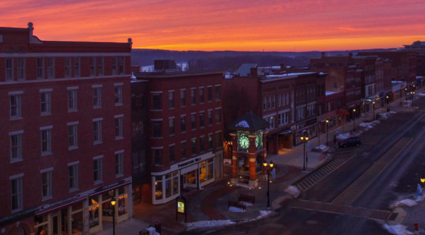 Historic downtown buildings with a colorful sunset
