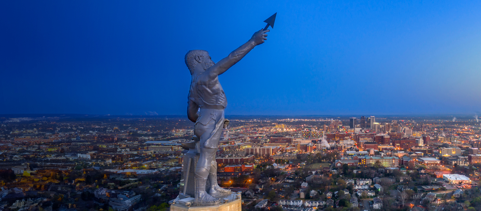 Aerial view of the Vulcan Statue with the city of Birmingham skyline in the background.
